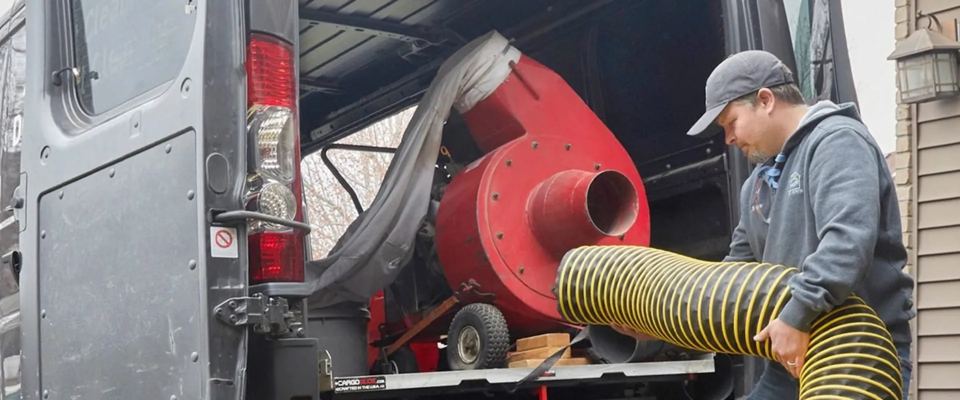 AC repair technician diagnosing outdoor unit at Dallas home